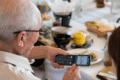 Elderly mnan holding a flip phone
