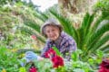 Elderly woman tending to her garden