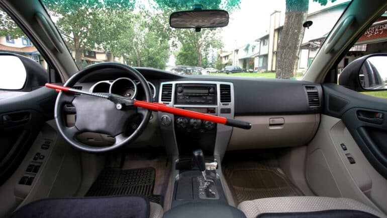 interior view of a car with a red steering wheel lock