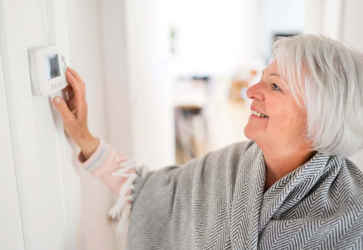 Woman adjusting smart home tech